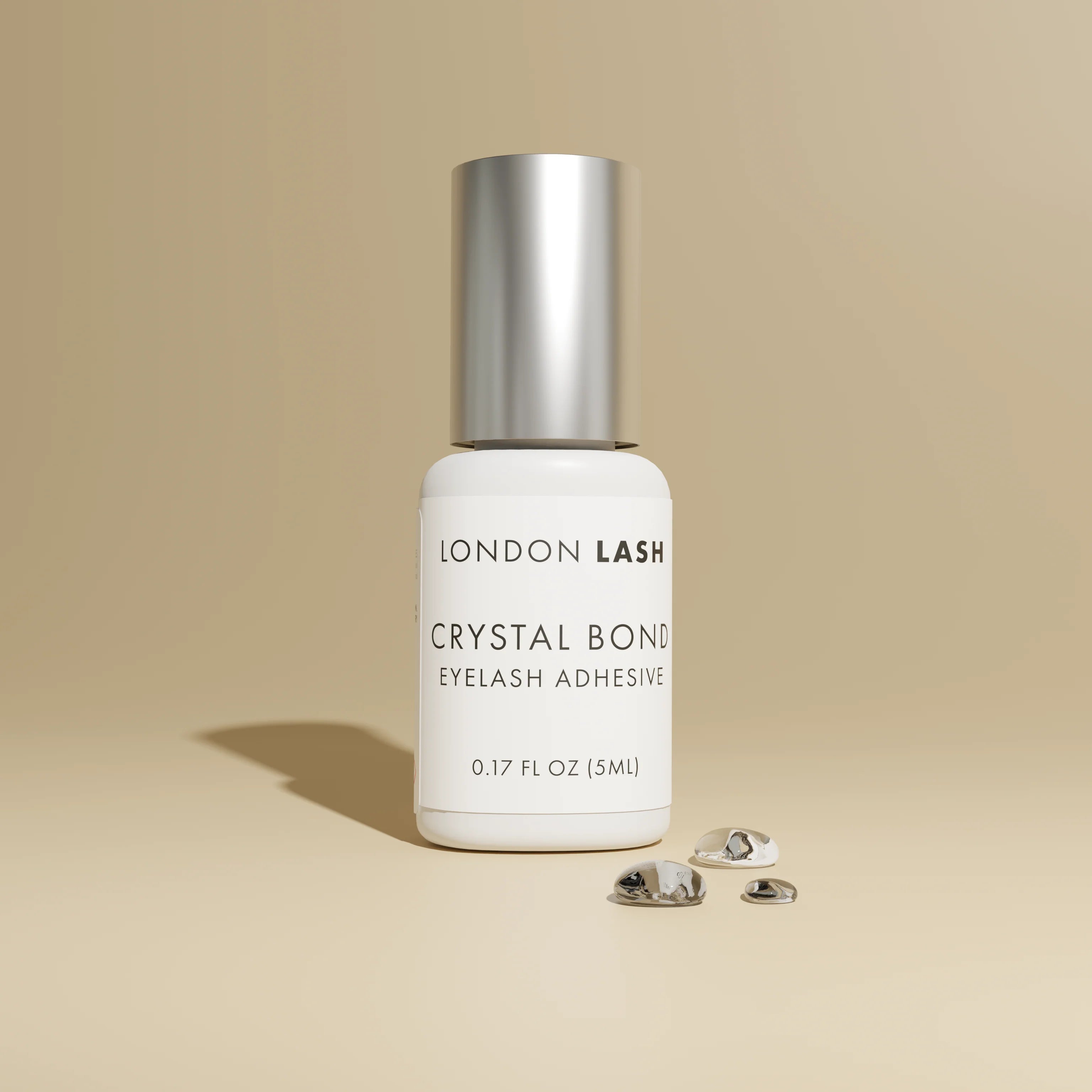London Lash Glue Subscription - Crystal Bond Eyelash Adhesive bottle on beige background