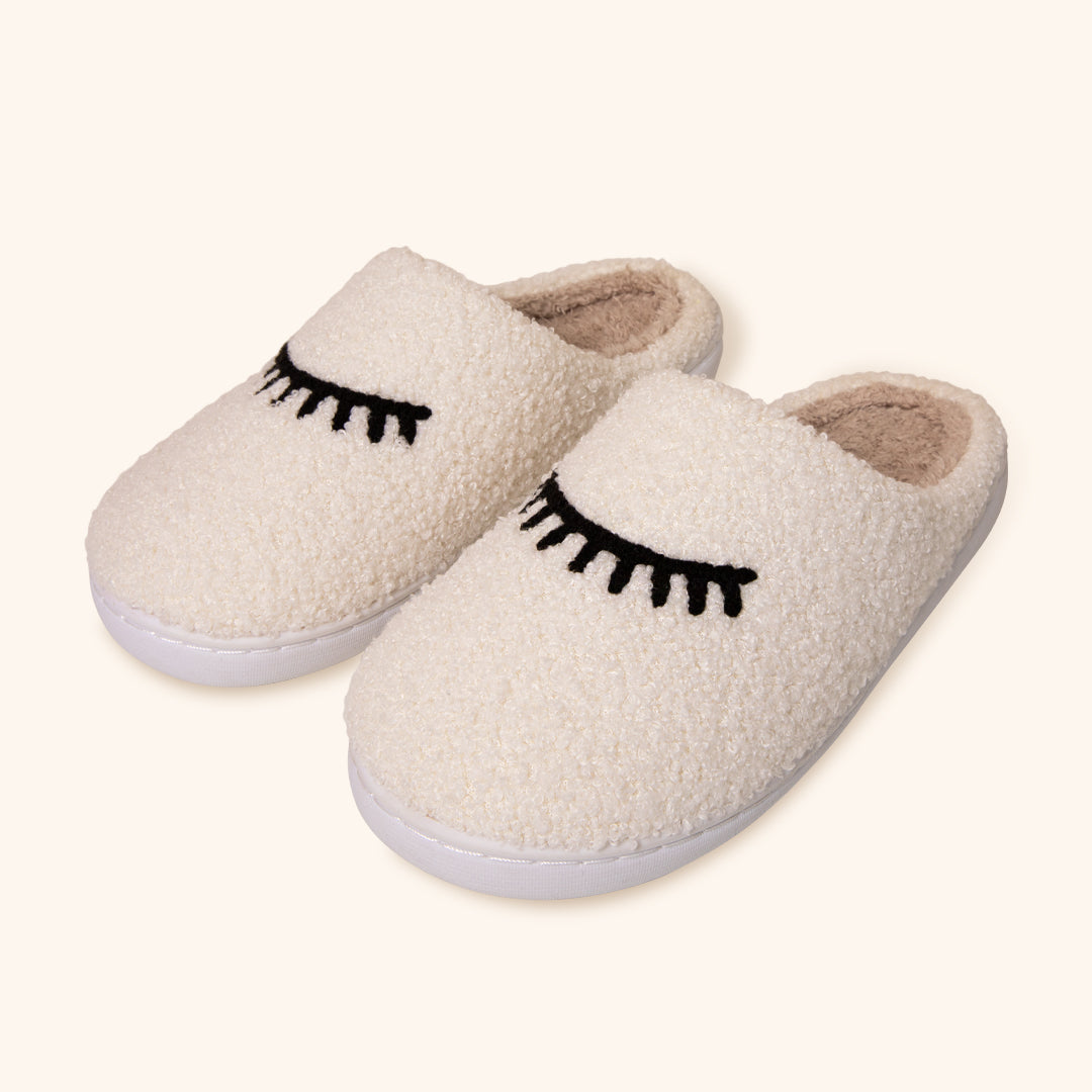 Pantufas de pelúcia aconchegantes com design de pestanas